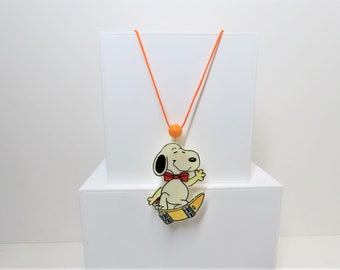 Vintage 1980s Snoopy skateboarder pull string motion necklace