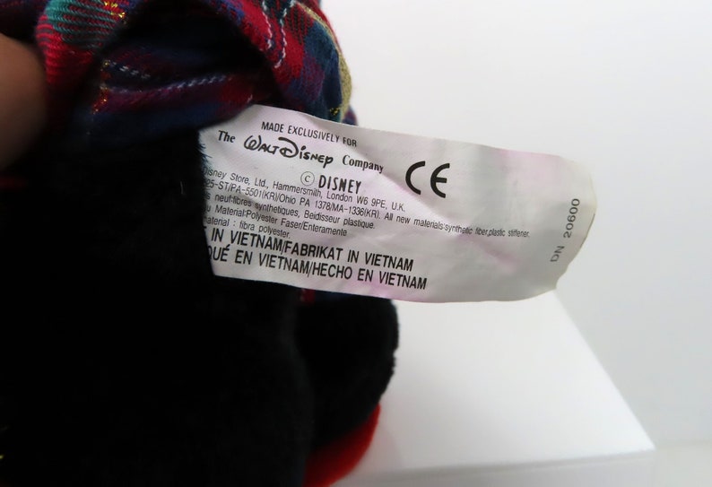 May include: A white tag with black text that reads "MADE EXCLUSIVELY FOR The WALT DISNEY Company &copy;DISNEY CE Disney Store, Ltd, Hammersmith, London W6 9PE, UK 5-ST/PA-5501KRO PA 1378 MA-1336K/AL All new materials-synthetique fiber/plastic softener Material: Polyester Faser/Enteramente material: fibra polyester IN VIETNAM FABRIKAT IN VIETNAM QUE EN VIETNAM/HECHO EN VIETNAM DN 20600".