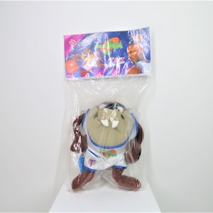 A vintage 1996 Space jam Taz toy in unopened packaging.