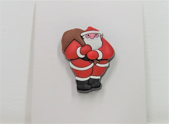 A Raymond Briggs Father Christmas pin badge.