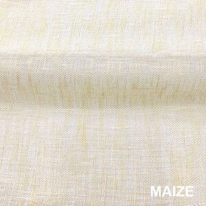 May include: Close-up of a beige fabric with a woven texture. The fabric has a subtle sheen and a slightly rough feel. The word "MAIZE" is printed in black at the bottom of the image.