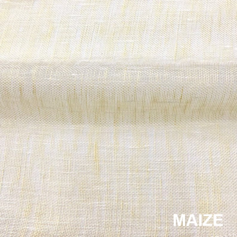 May include: Close-up of a beige fabric with a woven texture. The fabric has a subtle sheen and a slightly rough feel. The word "MAIZE" is printed in black at the bottom of the image.