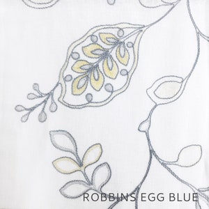 May include: White fabric with an embroidered pattern of gray and yellow leaves. The text "ROBBINS EGG BLUE" is printed at the bottom of the image.