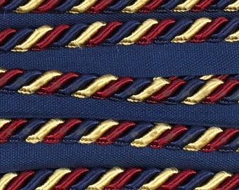 May include: Close-up of a navy blue fabric with a braided trim in gold, red, and navy blue. The trim is repeated in rows. The text "NAVY GOLD WINE" is at the bottom of the image.