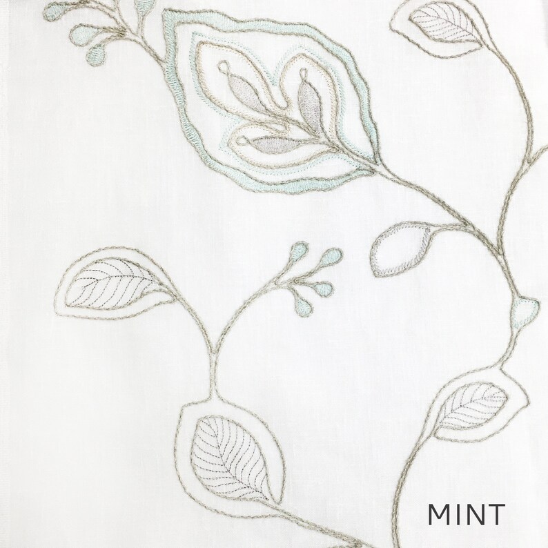 May include: White fabric with a delicate embroidered design of leaves and vines in shades of gray and light blue. The word "MINT" is printed in the bottom right corner.