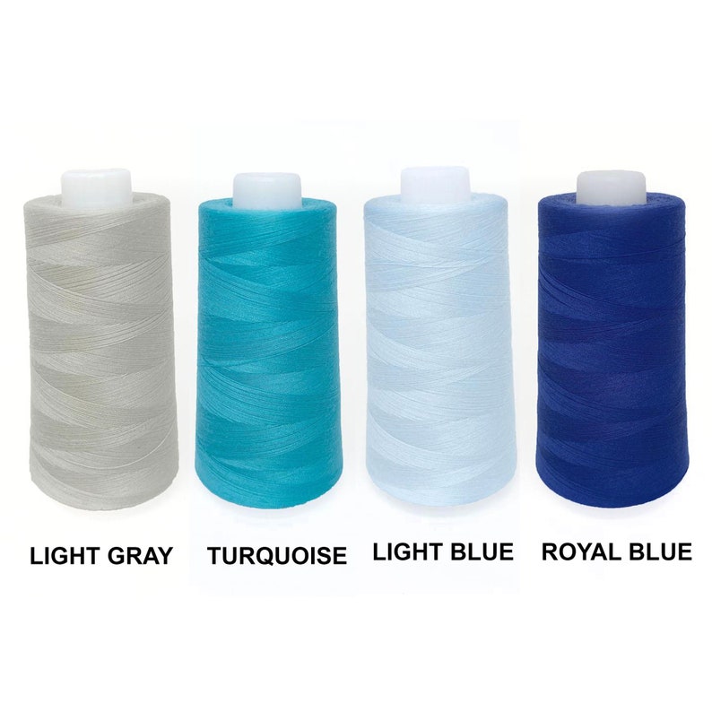 May include: Four spools of thread in different colors: light gray, turquoise, light blue, and royal blue.