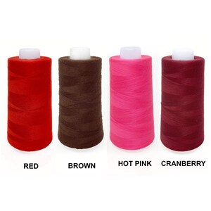 May include: Four spools of thread in red, brown, hot pink, and cranberry.