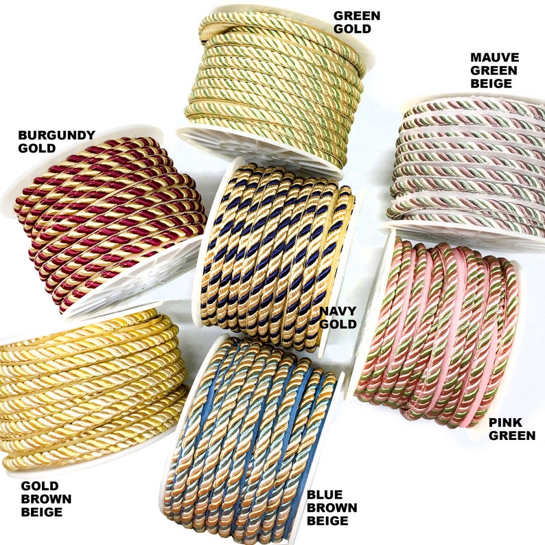 May include: Assortment of braided trim in various colors, including gold, green, navy, burgundy, pink, and blue. Each trim features a combination of two colors, creating a striped effect.
