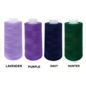 May include: Four spools of thread in lavender, purple, navy blue, and hunter green.