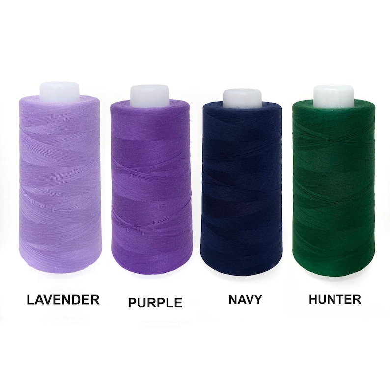 May include: Four spools of thread in lavender, purple, navy blue, and hunter green.