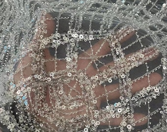 May include: White mesh fabric with silver sequins in a geometric pattern.