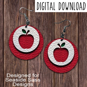 May include: A pair of red and white round earrings with a red apple design. The earrings are designed for use with earring blanks.