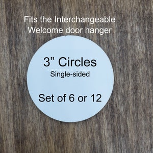 May include: A light blue, single-sided circle with the text "3" Circles" and "Set of 6 or 12". The text "Fits the Interchangeable Welcome door hanger" is at the top. The circle is 3 inches in diameter.