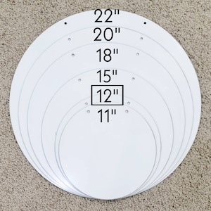 May include: Set of 7 round white cake boards in various sizes: 11", 12", 15", 18", 20", and 22".