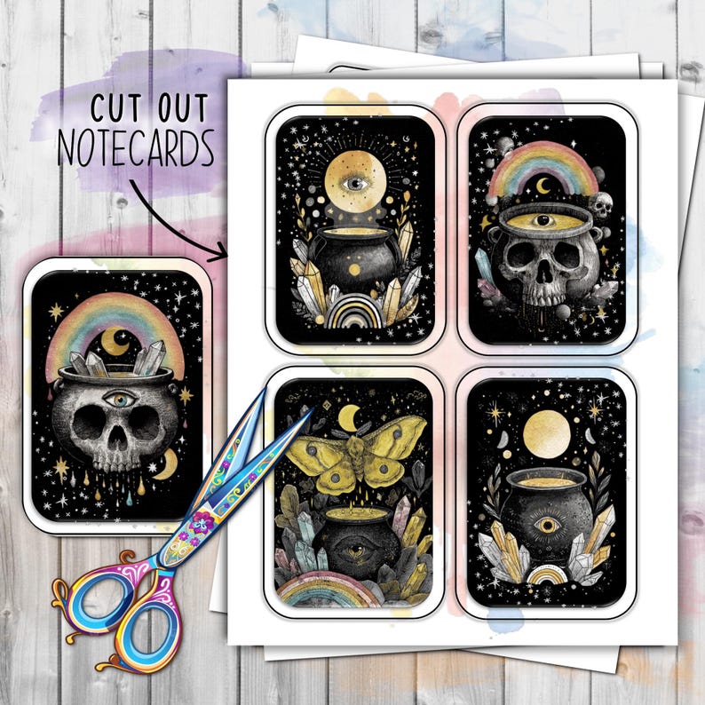 May include: A sheet of cut-out notecards with mystical illustrations. The cards feature a skull, cauldron, butterfly, and eye designs with rainbows, crystals, and celestial elements. The text "CUT OUT NOTECARDS" is visible.