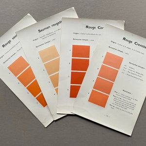 May include: Four color swatches on separate sheets of paper, each with a different shade of red. The swatches are labeled "Rouge Saumon", "Saumon rougeât", "Rouge Cor", and "Rouge Crevette".