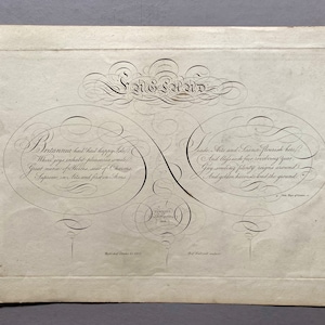 May include: A black and white print of a calligraphic design with the text "Sag Sand" at the top. The design features two circles with text inside, one circle says "Britannia had had happy isle" and the other circle says "Trade, Arts and Science flourish here".