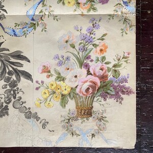 May include: A vintage floral wallpaper design featuring a bouquet of pink, white, yellow, and purple flowers in a woven basket. The flowers are surrounded by smaller floral sprigs and a blue ribbon.