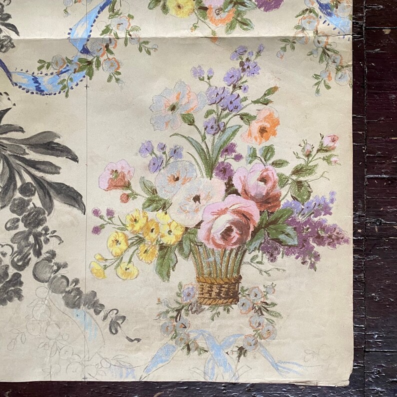 May include: A vintage floral wallpaper design featuring a bouquet of pink, white, yellow, and purple flowers in a woven basket. The flowers are surrounded by smaller floral sprigs and a blue ribbon.