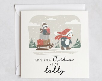 May include: A Christmas card with a penguin pulling a sled with a penguin on it. The card says "Happy First Christmas as my Daddy".