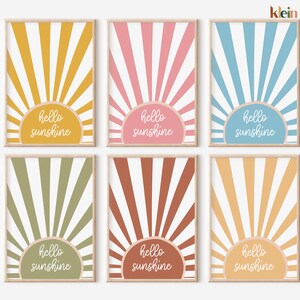 May include: Set of six printable wall art prints featuring a sunburst design in various colors, including yellow, pink, blue, green, brown, and orange. Each print features the text "hello sunshine" in white.