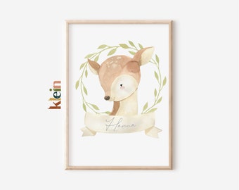 May include: A watercolor illustration of a fawn with a brown and white spotted coat. The fawn is surrounded by a green leafy wreath and a banner with the name "Hanna" written in cursive.