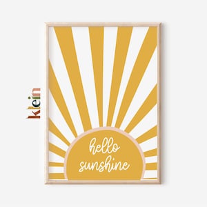 May include: A yellow and white sunburst design with a pink circle in the center that says "hello sunshine".
