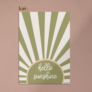 May include: Green and white striped sunburst design with a peach-colored circle in the center. The circle has the text "hello sunshine" in white.