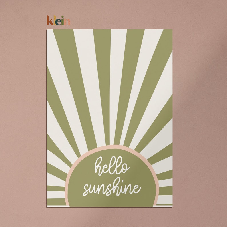 May include: Green and white striped sunburst design with a peach-colored circle in the center. The circle has the text "hello sunshine" in white.