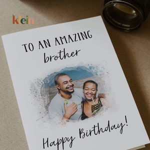 May include: A white card with a watercolor background and a photo of two people smiling. The card says "To an amazing brother Happy Birthday!"
