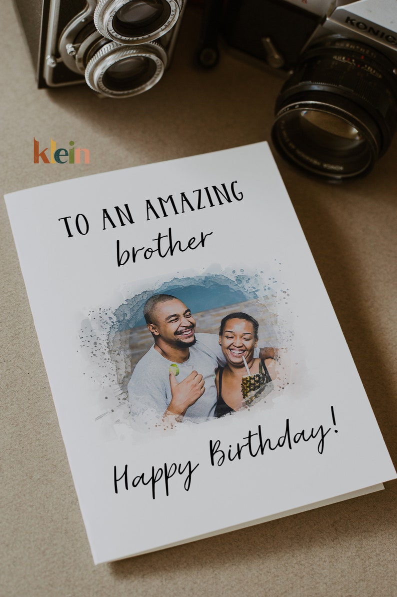 May include: A white card with a watercolor background and a photo of two people smiling. The card says "To an amazing brother Happy Birthday!"
