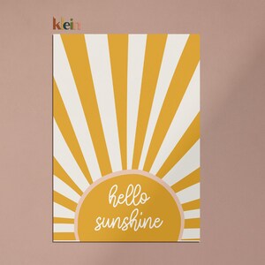 May include: A yellow and white sunburst design with the text "hello sunshine" in a peach-colored circle.