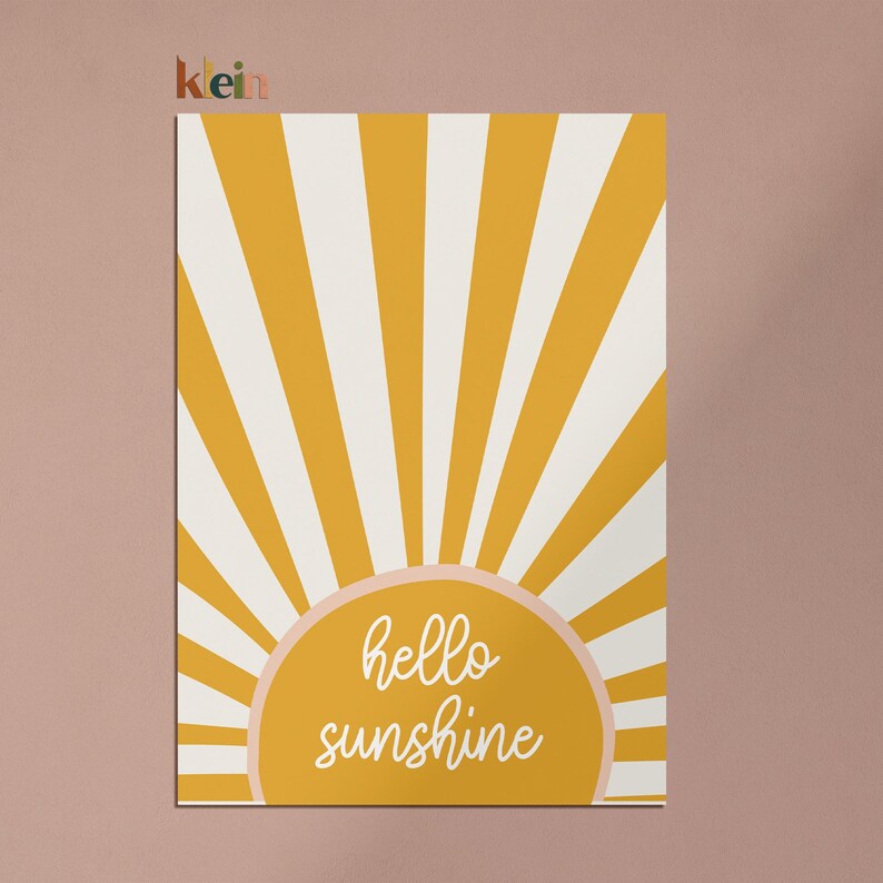 May include: A yellow and white sunburst design with the text "hello sunshine" in a peach-colored circle.