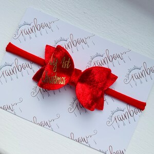 May include: Red velvet bow with a gold glitter "My 1st Christmas" inscription on a red headband.