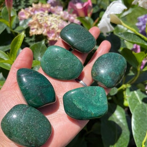 May include: Six smooth, green aventurine tumbled stones. The stones are various sizes and shapes, with a glossy finish.
