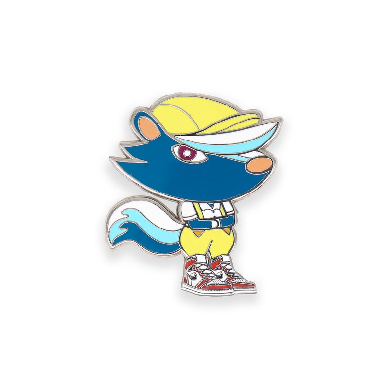 May include: A blue and white enamel pin featuring a cartoon animal wearing a yellow hat and red and white sneakers. The animal has a white tail and a red eye.
