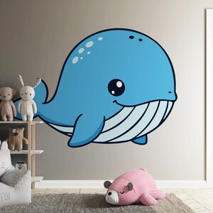May include: A large, cartoon-style blue whale wall decal with a smiling face and white stripes on its belly. The whale is affixed to a neutral-colored wall in a child's room. Other toys and furniture are visible.
