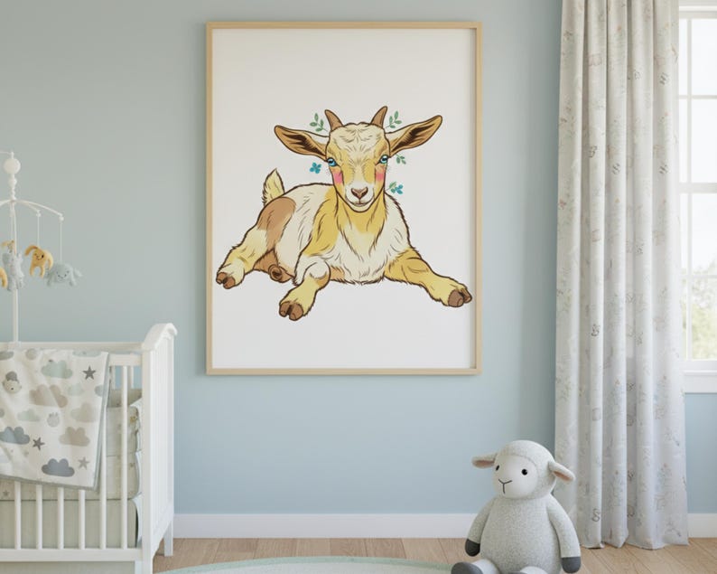 May include: A framed art print of a cartoon goat in yellow, brown, and white, with small green floral accents. The goat is lying down, facing forward. The artwork is displayed in a light-coloured wooden frame, suitable for a nursery or child's room.