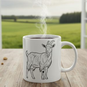 May include: White ceramic mug with a black and white goat illustration. The mug holds a dark liquid, with steam rising. The mug sits on a wooden surface, with a green field visible through a window in the background.
