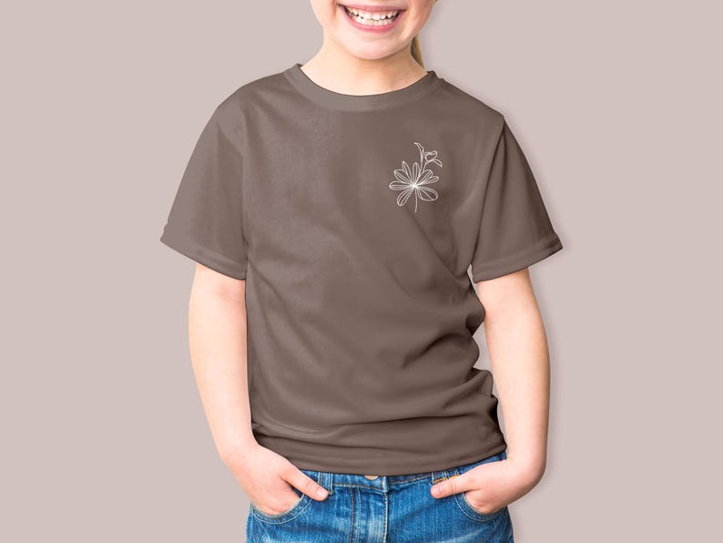 May include: A brown t-shirt with a white line drawing of a flower on the left chest.