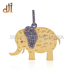 May include: A gold elephant pendant with black diamond accents and a pink gemstone eye. The pendant is made of sterling silver and is a great addition to any jewelry collection.