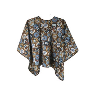 May include: A brown and blue patterned cape with a rounded neckline and a dog design. The cape is made of a soft, comfortable fabric and is perfect for protecting your clothes from hair and other debris.