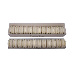 May include: A box of 18 white macarons, arranged in two rows. The box is white with the words "Macaron Bites" printed on the front.