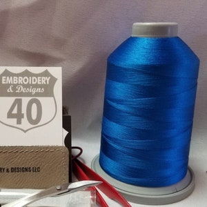 May include: A spool of bright blue embroidery thread with a white label that says "Embroidery & Designs 40".