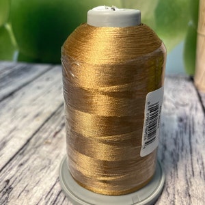 May include: A spool of gold embroidery thread with a white label that reads "92589 15565 8".