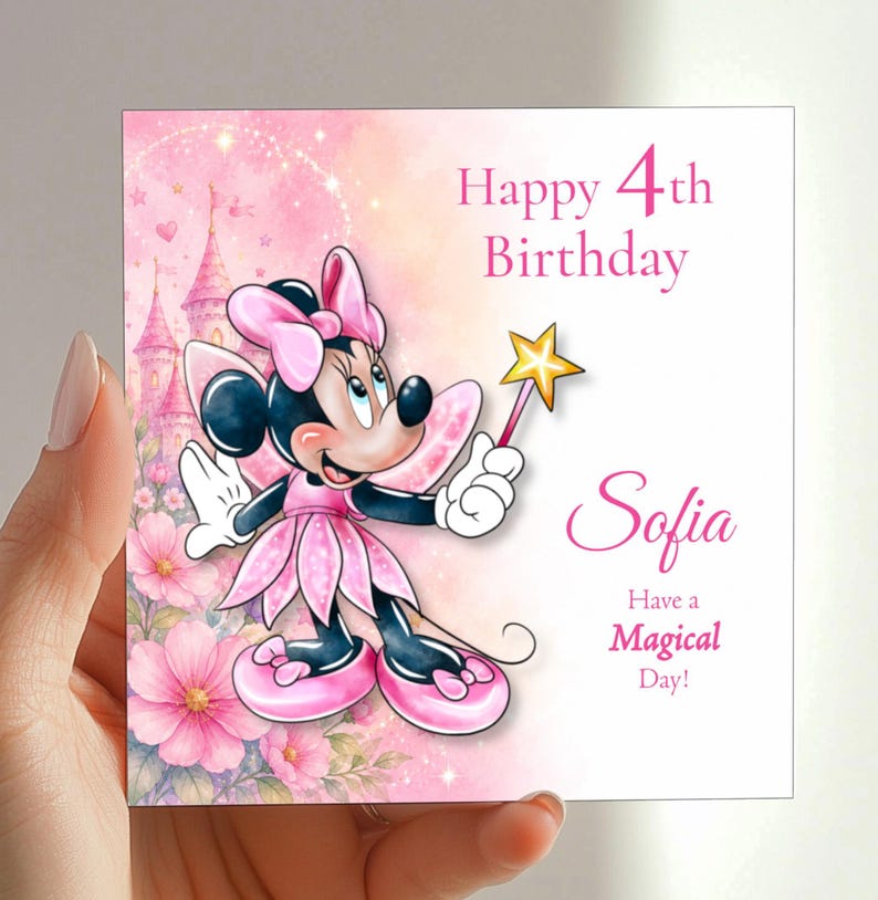A hand holding a birthday card with a Minnie Mouse character and a pink background with flowers.