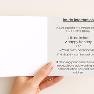 a person's hand holding a blank card with instructions on how to fill it out.