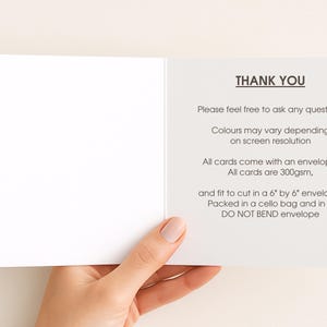 A hand holding a blank card with instructions on how to fill it.