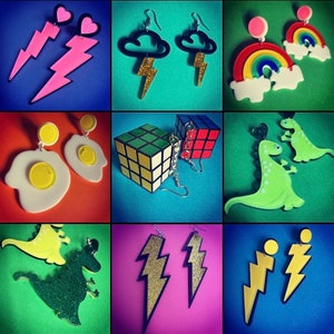 May include: A collage of 12 different pairs of earrings. The earrings are made of various materials, including plastic, metal, and glitter. The earrings feature a variety of designs, including hearts, lightning bolts, rainbows, dinosaurs, and game controllers.