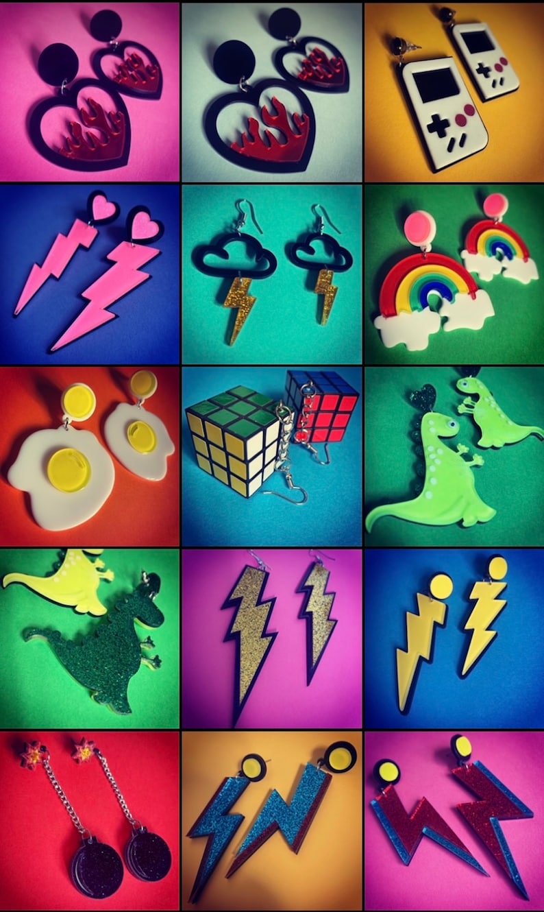 May include: A collage of 12 different pairs of earrings. The earrings are made of various materials, including plastic, metal, and glitter. The earrings feature a variety of designs, including hearts, lightning bolts, rainbows, dinosaurs, and game controllers.